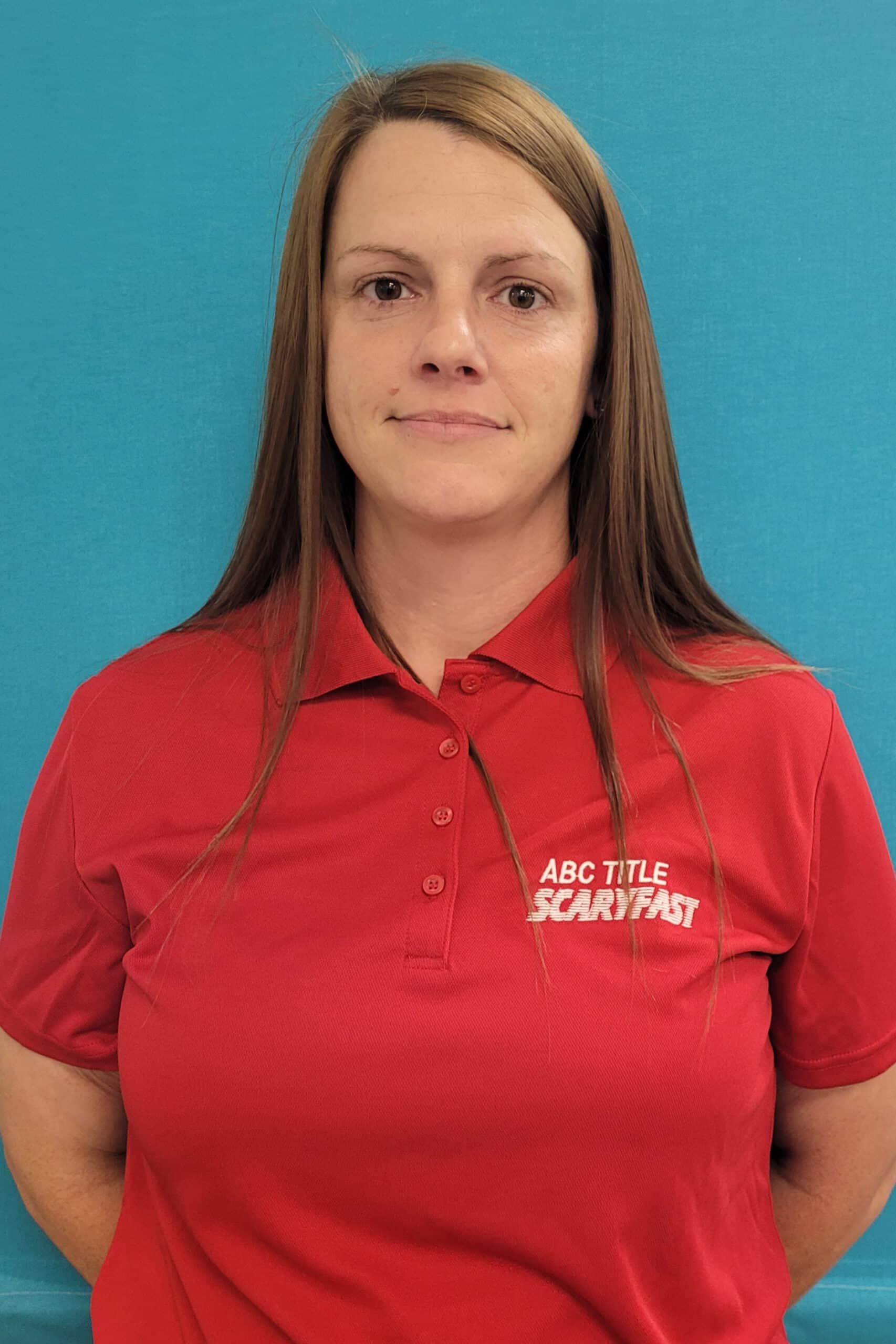 ABC Title A woman wearing a red polo shirt.